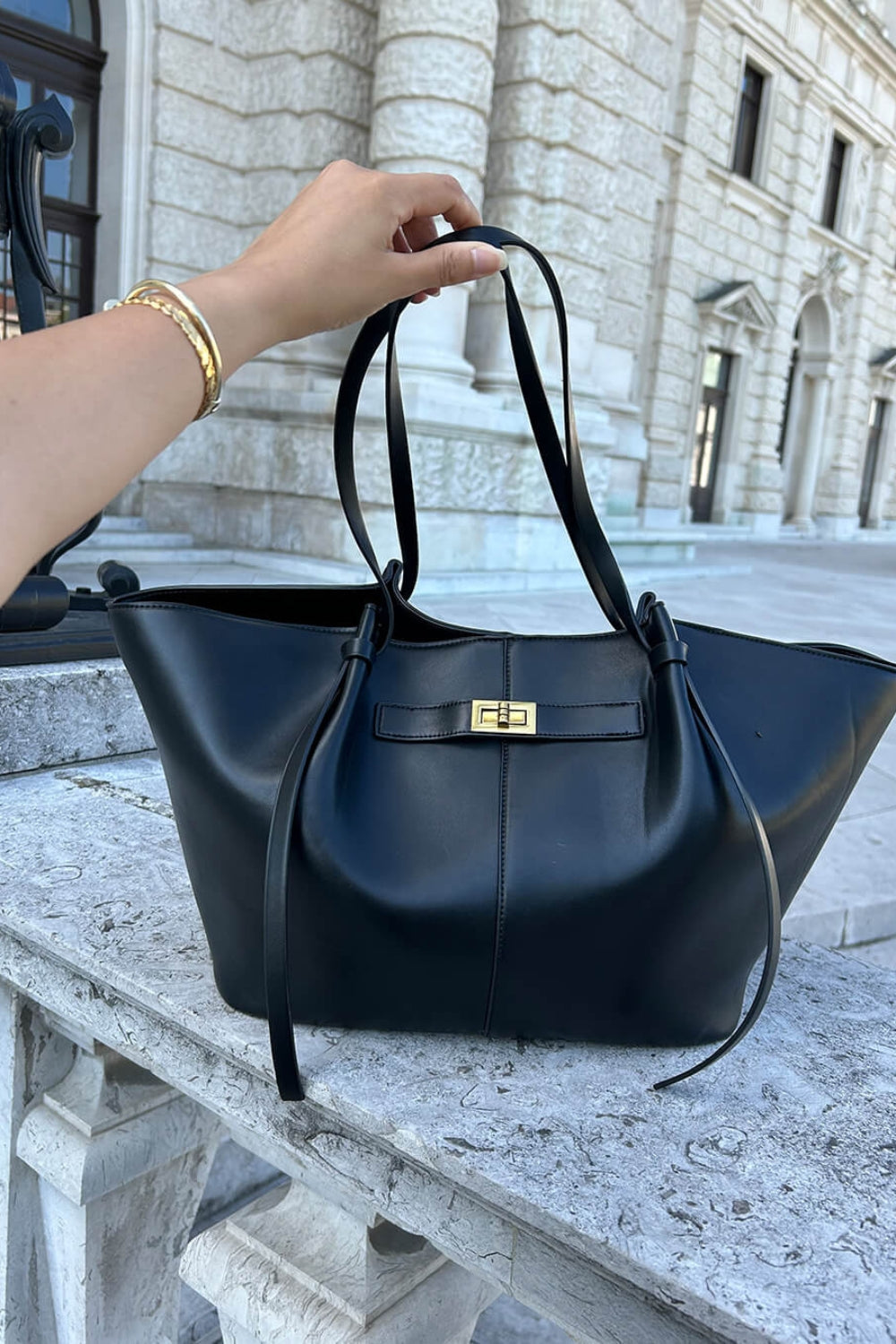 Everyday leather tote with a clasp detail on the front.